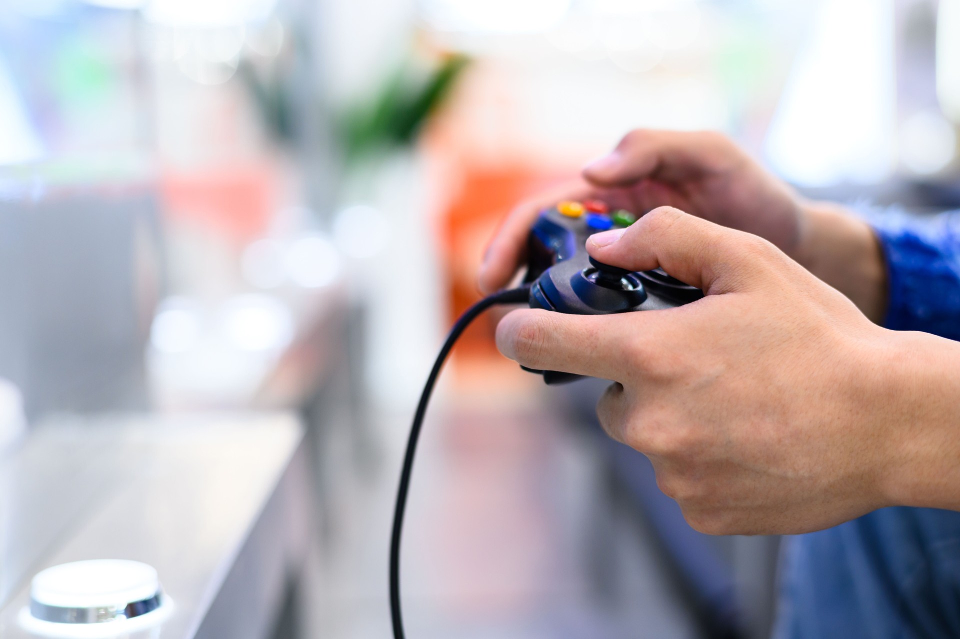 Asian young man playing video game with game controller